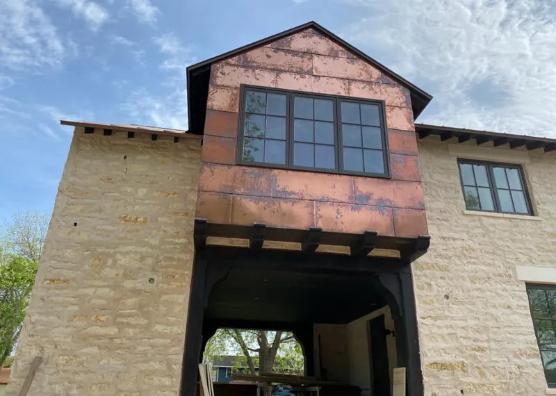 Copper metal panel facade on a stone building for Skylight Installation in Newnan