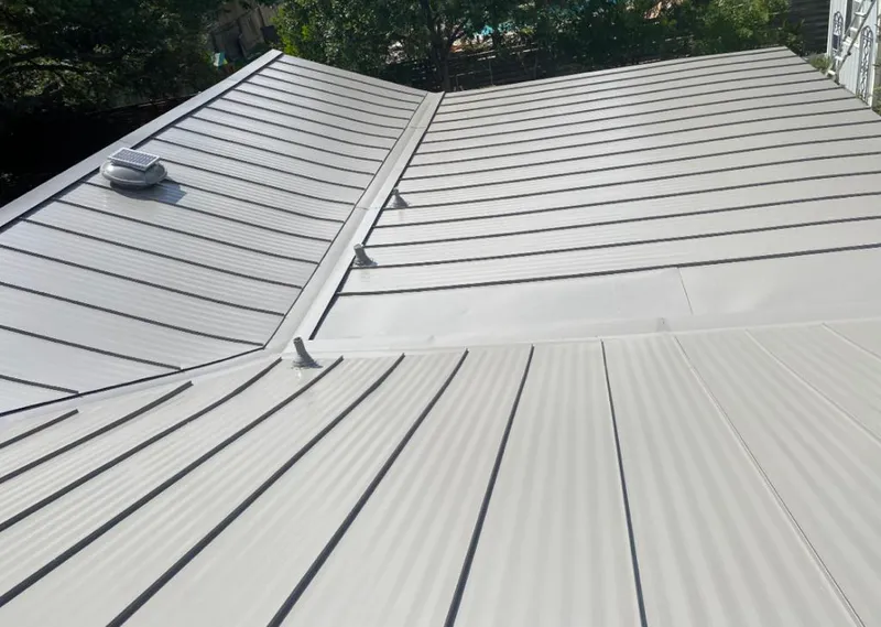 Solar attic fan installed on a metal roof for Roof Ventilation in Newnan